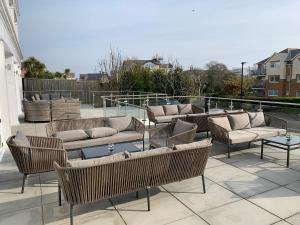 a group of chairs and couches on a patio at The Fig Tree Hotel in Shanklin