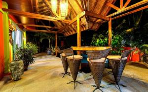 a restaurant with chairs and a table and a wooden ceiling at Chaba Pool Villa in Nai Harn Beach