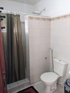a bathroom with a toilet and a shower at BH Studio Casa grande em Fortaleza in Fortaleza