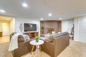 a living room with a couch and a fireplace at Aurora Vacation Rental 9 Mi to Downtown Denver in Aurora