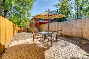 a patio with a table and chairs and an umbrella at Aurora Vacation Rental 9 Mi to Downtown Denver in Aurora