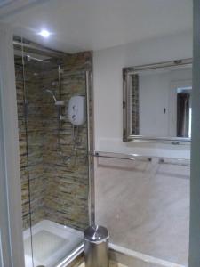 a shower with a glass door in a bathroom at The Whitehouse Ross-On-Wye in Ross on Wye