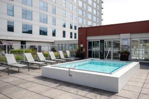 a pool in a courtyard with chairs and a building at South Loop 1br w gym game room nr top schools CHI-988 in Chicago