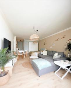 a living room with a couch and a table at Studio Sea View - Royal Ascot in Ostend
