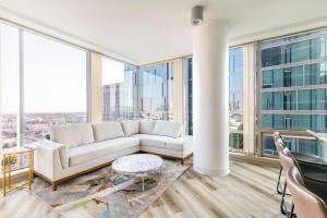 a living room with a couch and large windows at 2BR Lux Highrise Hollywood in Los Angeles