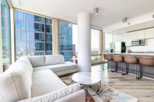 a living room with a couch and a table at 2BR Lux Highrise Hollywood in Los Angeles