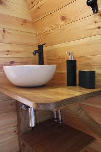 a bathroom with a white sink on a wooden counter at Quinta da Devesa -B2 in Vinhais