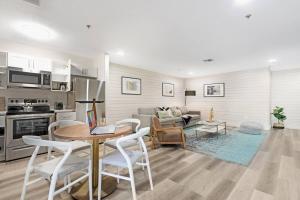 a kitchen and living room with a table and chairs at The Lofts on Clematis 203 Downtown West Palm Beach in West Palm Beach