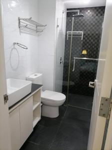 a bathroom with a toilet and a sink and a shower at 2 Bedroom Condo in Cebu - opp Ayala in Cebu City