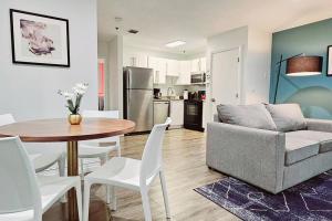 a living room and kitchen with a table and a couch at The Lofts on Clematis 204 Downtown West Palm Beach in West Palm Beach