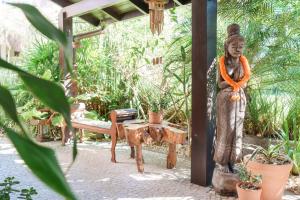 a statue of a woman standing in a garden at Casa Mar Campeche in Florianópolis