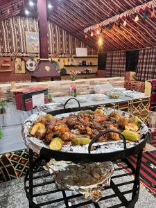 a table with a tray of food on a grill at Wadi Rum Trip in Wadi Rum +52 photos