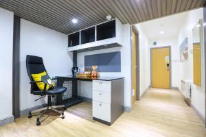 a office with a desk and a chair in a room at A105 Stylish City loft in Coventry