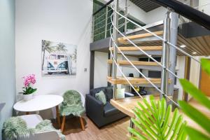 a loft apartment with a spiral staircase and a living room at A105 Stylish City loft in Coventry