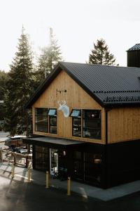 a large wooden building with a black roof at Gravity Haus Winter Park in Winter Park