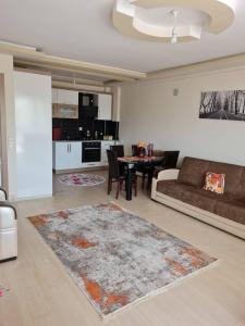 a living room with a couch and a table at Cozy two-room apartment for living in Erdemli