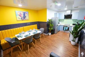 a dining room with a table and chairs and a kitchen at A105 Stylish City loft in Coventry