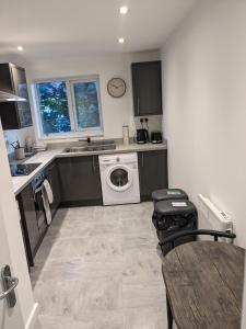 a kitchen with a washing machine and a washer and dryer at Jesmond heart stays in Hartlepool