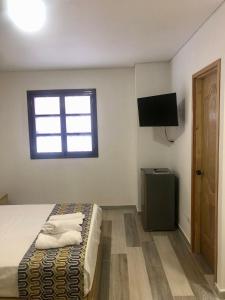 TV a/nebo společenská místnost v ubytování ALTO VERDE HOTEL