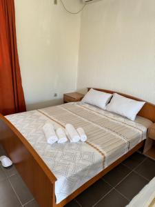 a bedroom with a bed with two towels on it at Apartments Airport Golubovci in Podgorica
