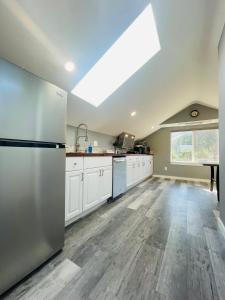 a kitchen with a stainless steel refrigerator and white cabinets at Green Lake 1st Line Home B with Central Air Conditioners in Seattle