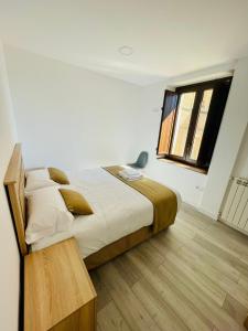 a bedroom with a large bed and a window at Apartamentos Rurales La Plaza 1 in Duruelo de la Sierra