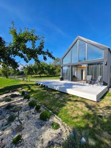 a large glass house with a large deck at Elizjum pod Śnieżką in Bukowiec