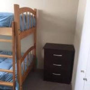 a bedroom with two bunk beds and a wooden dresser at Marina La Serena, Playa Cuatro Esquinas in La Serena