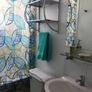 a bathroom with a sink and a toilet and a mirror at Marina La Serena, Playa Cuatro Esquinas in La Serena