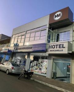 a motorcycle parked in front of a hotel at Hotel Mascarello in Planalto