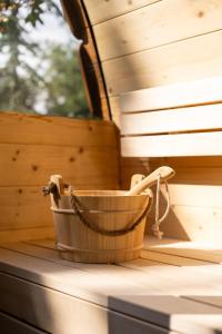 a wooden bucket sitting on the inside of a sauna at Gileston Manor Luxury B&B in Barry