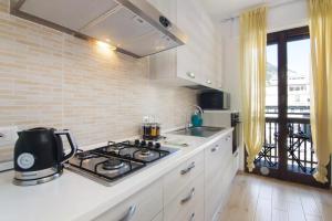 a kitchen with a stove and a counter top at Mary House in Sondrio