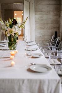 a long table with white plates and candles and flowers at Dwór Cieszkowskich 