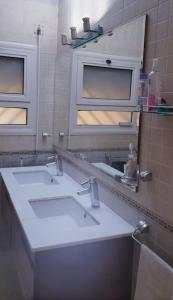 a bathroom with a white sink and a mirror at 3 bedroom Villa W/ beach access in Hurghada