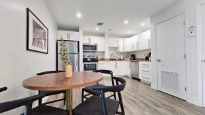 a kitchen with a wooden table and chairs at The Lofts on Clematis 408 Downtown West Palm Beach in West Palm Beach