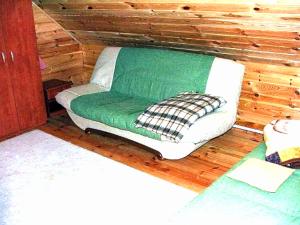a room with a green couch in a cabin at Tropicana Ϫϫ Holiday Houses in Jastrzębia Góra