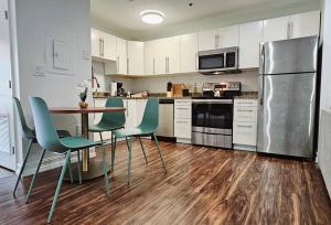 a kitchen with a table and chairs and a refrigerator at The Lofts on Clematis 503 Downtown West Palm Beach in West Palm Beach