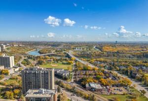 an aerial view of a city with trees and buildings at Only 5 minutes to Rogers with Free Downtown Parking in Edmonton