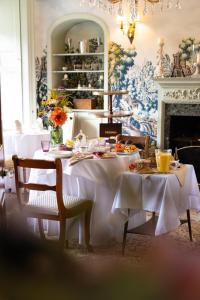 a dining room with a table with food on it at Gileston Manor Luxury B&B in Barry