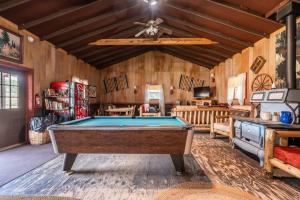 a pool table in a room with wooden walls at New! Charming cozy Cabin Colorado National Forest in Lake George
