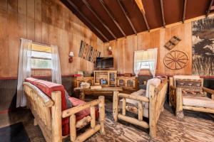 a room with couches and a table and a television at New! Charming cozy Cabin Colorado National Forest in Lake George