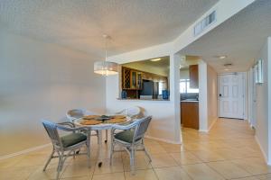 a dining room with a table and chairs at Heated Pool Access Clearwater Beachfront Condo! in Clearwater Beach