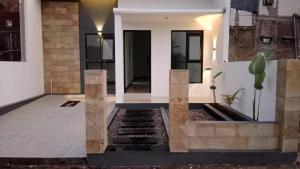 a houserendering of a front porch of a house at NG Shelter Homestay & Daycare in Karawang
