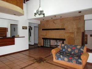 a living room with a couch and a stone fireplace at HOTEL LA TOSCANA in San Ignacio