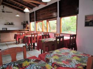 a restaurant with tables and chairs in a room at HOTEL LA TOSCANA in San Ignacio