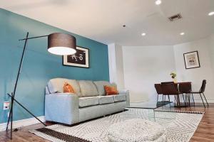 a living room with a couch and a table at The Lofts on Clematis 402 Downtown West Palm Beach in West Palm Beach