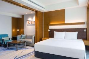 a hotel room with a bed and a chair at Radisson Blu Cebu in Cebu City