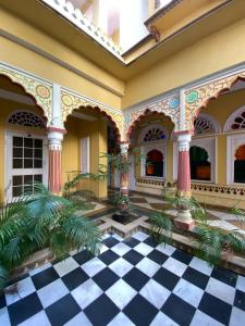 a lobby of a building with a black and white checkered floor at Sureli Haveli in Jaipur