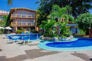 a resort with a swimming pool and a resort at Bungalows Omar Deluxe in Rincon de Guayabitos