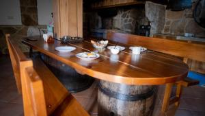 a kitchen with a wooden counter with a wooden table at Casa dos do Carvalho - Miradouro da Branda in Branda de Santo António